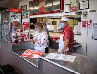 2 states announce new virus restrictions as US cases hit 11 mln