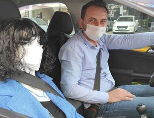 Taxi driver rides with dummy in front passenger seat to enforce social distancing