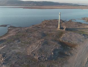 Submerged village revealed after drop in rainfall
