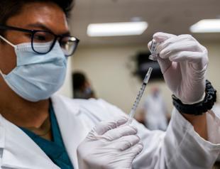 US begins COVID-19 vaccinations as its death toll passes 300,000