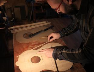Young luthier produces guitars for musicians worldwide