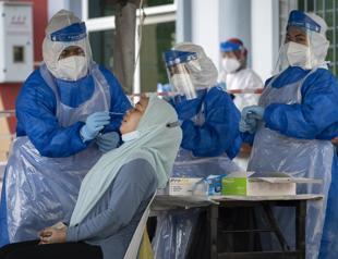 COVID surges dim hopes for speedy end to pandemic