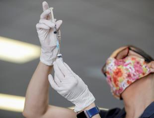 UK virus jabs hit first target as N Zealand puts city in lockdown