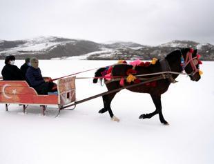 Sleigh rides on frozen lake attract visitors