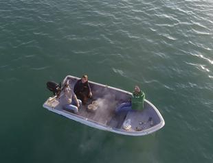 Friends make barbeque on boat due to virus restrictions on land