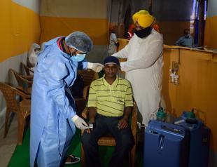 Britain set to ease virus lockdown, but huge India outbreak persists