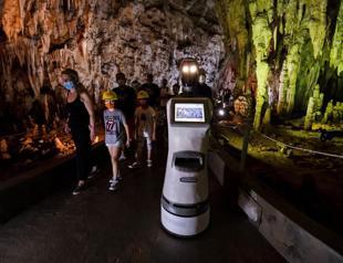 Robot guide leads visitors in a Greek cave