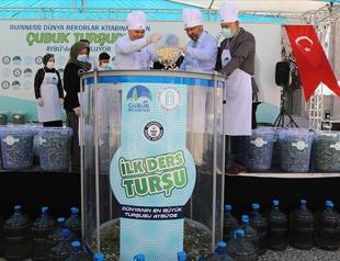 Students, lecturers prepare massive jar of pickle before academic year begins