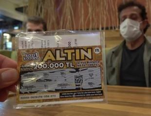 Son hits bullseye with scratch card father threw into wastebasket