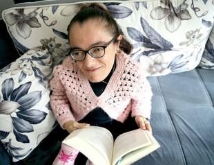 Woman with glass bone disease holds onto life with books
