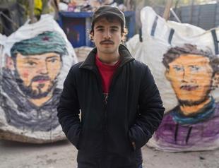 Artist paints paper collectors’ hand-pulled carts