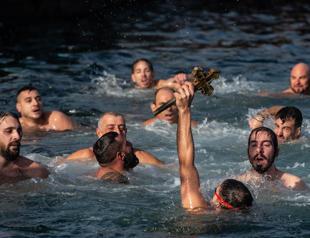 Orthodox Christians mark Epiphany with dive for cross