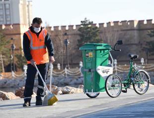 Sanitation workers with bikes on roads in Konya