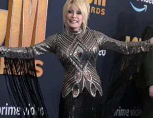 Against her wishes, Dolly Parton inducted into rock hall of fame