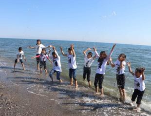 Children jump into sea they saw for first time
