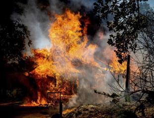 California wildfire rages as US bakes in record-setting heat wave