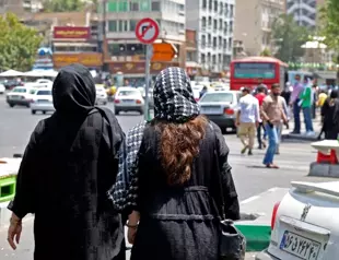 Iranian police fire tear gas at rally after woman’s funeral