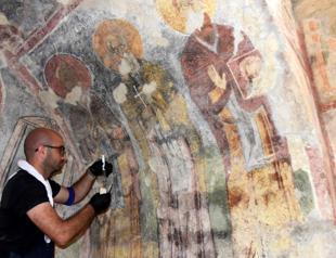 Wall paintings in St. Nicholas Museum being touched up