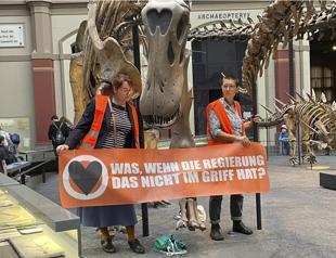 German eco activists glue themselves to dinosaur exhibit