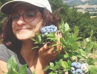 Young woman earns money from blueberries