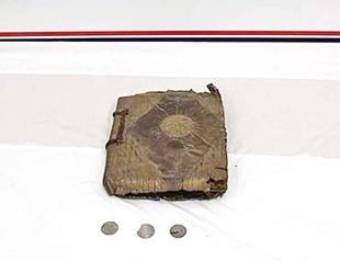 Handwritten Bible and three coins seized in vehicle