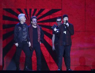 U2 returning to stage, minus one of quartet