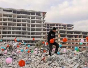 Balloons hung around rubble for children died in quake