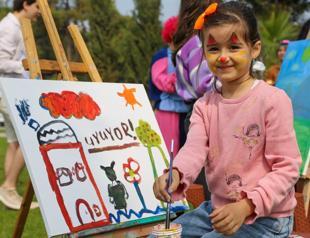 Quake survivor children painting at seaside
