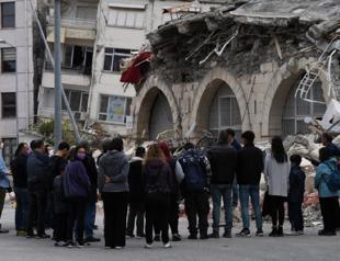 People hold mass in front of ruins of collapsed church