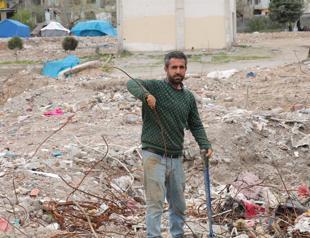 Man collects iron from debris to make money