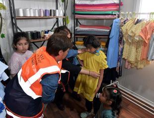 Quake-hit women produce clothes in container workshops