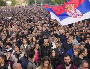 Thousands march in silence in Serbia after mass shootings