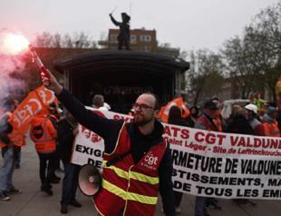 Macron vows to boost economy shaken by protests