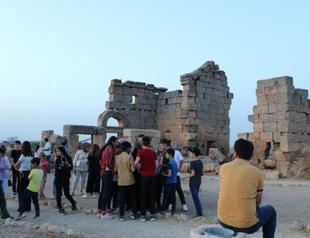 People observe sky from ancient castle