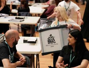 Ruling UK Conservatives suffer vote routs but avoid wipeout