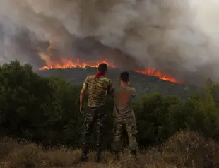Firefighters in Greece struggle to control wildfires, including the EUs largest blaze