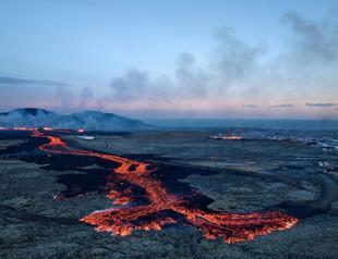 Volcano lava flows into Icelandic village, engulfing homes