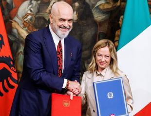 Albanian parliament approves contested migrant deal with Italy