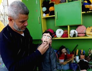 Gaza puppet maker turns tins into toys in ruins of war