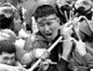 Thai PM defies protests to give first speech