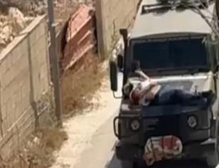 Israeli forces tie wounded Palestinian to jeep in West Bank raid