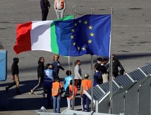 Italian navy brings first migrants to Albania under asylum deal