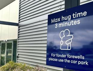 New Zealand airport sets three-minute limit on hugs