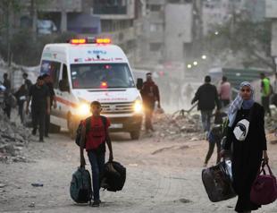 Gaza air strikes kill 94 as manhunt unfolds in West Bank