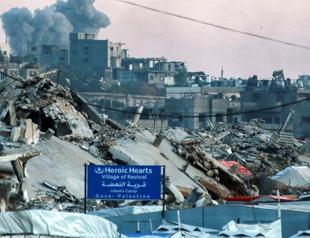 Gaza civil defense says Israeli attacks kill dozens near two aid centres