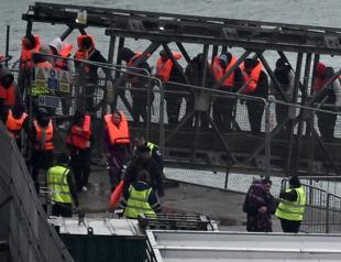 UK says first migrants held under return deal with France