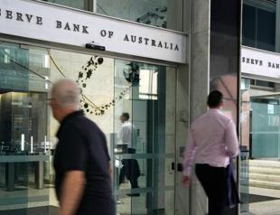 Australian central bank cuts key rate, warns of uncertainty