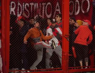 Ten hurt as match abandoned following fan violence