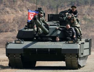 North Korean leader, daughter try out new tank