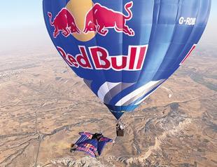 Wingsuit athletes fly among hot air balloons over Cappadocia